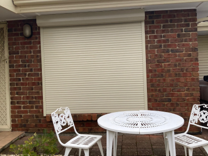 Closeup of Yellow and Blue Wall with Closed Shutters